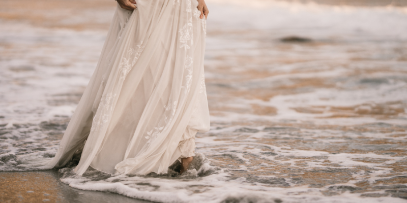 Plan for Unpredictable Weather Woman walking in ocean in wedding dress