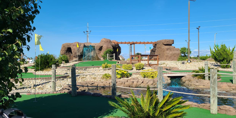 Paradise Fun Park Image of golf course with waterfall and river.