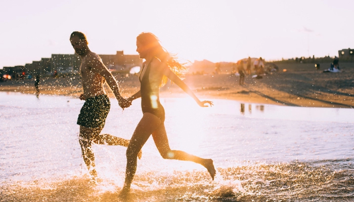 couple running into the water